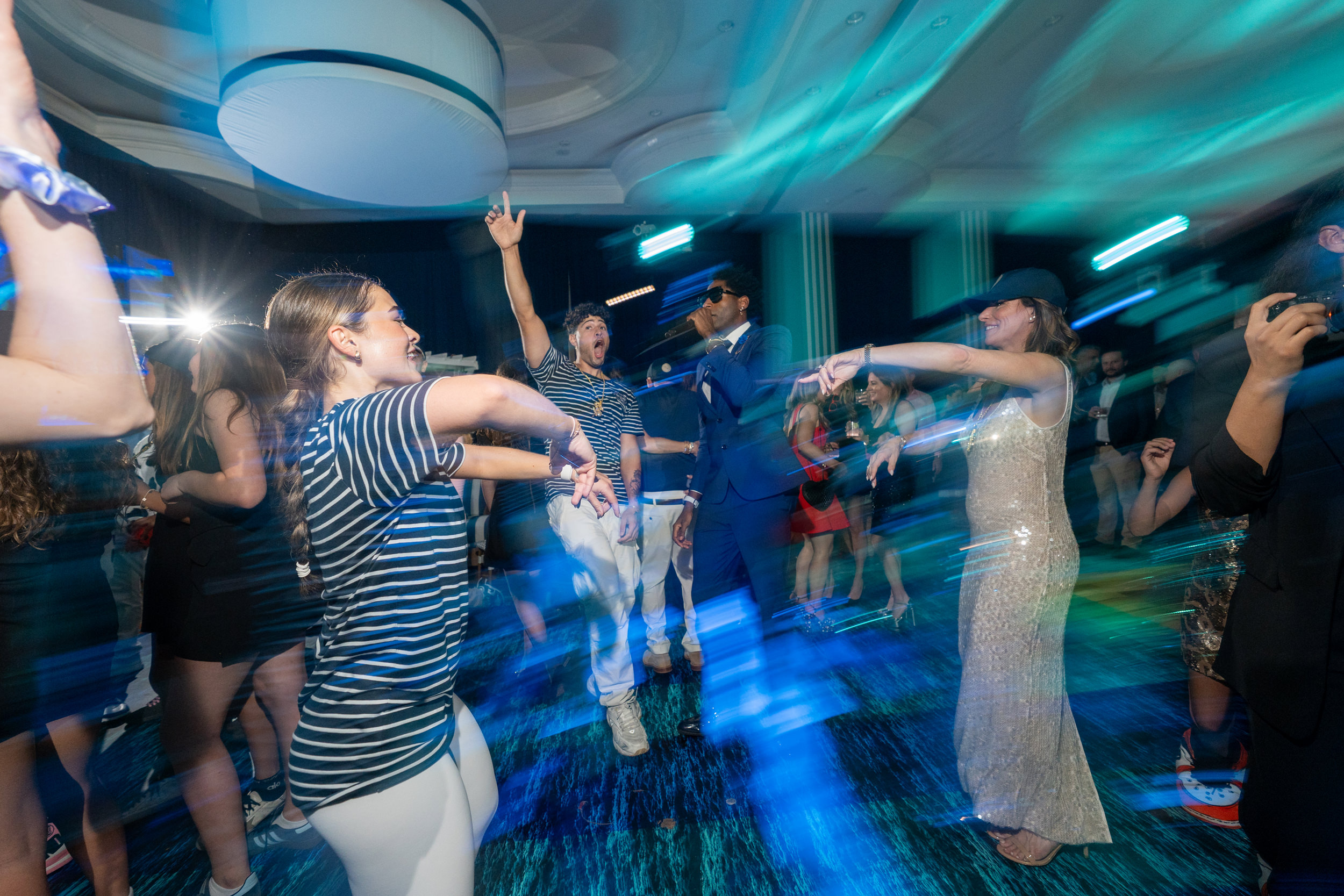Guests enjoying interactive entertainment on the dance floor at a luxury celebration